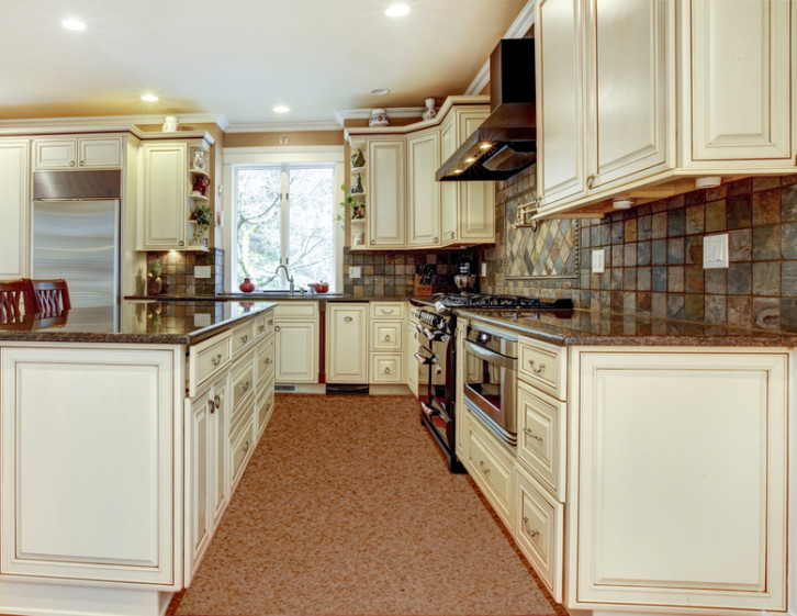 Large luxury white kitchen with cherry hardwood.